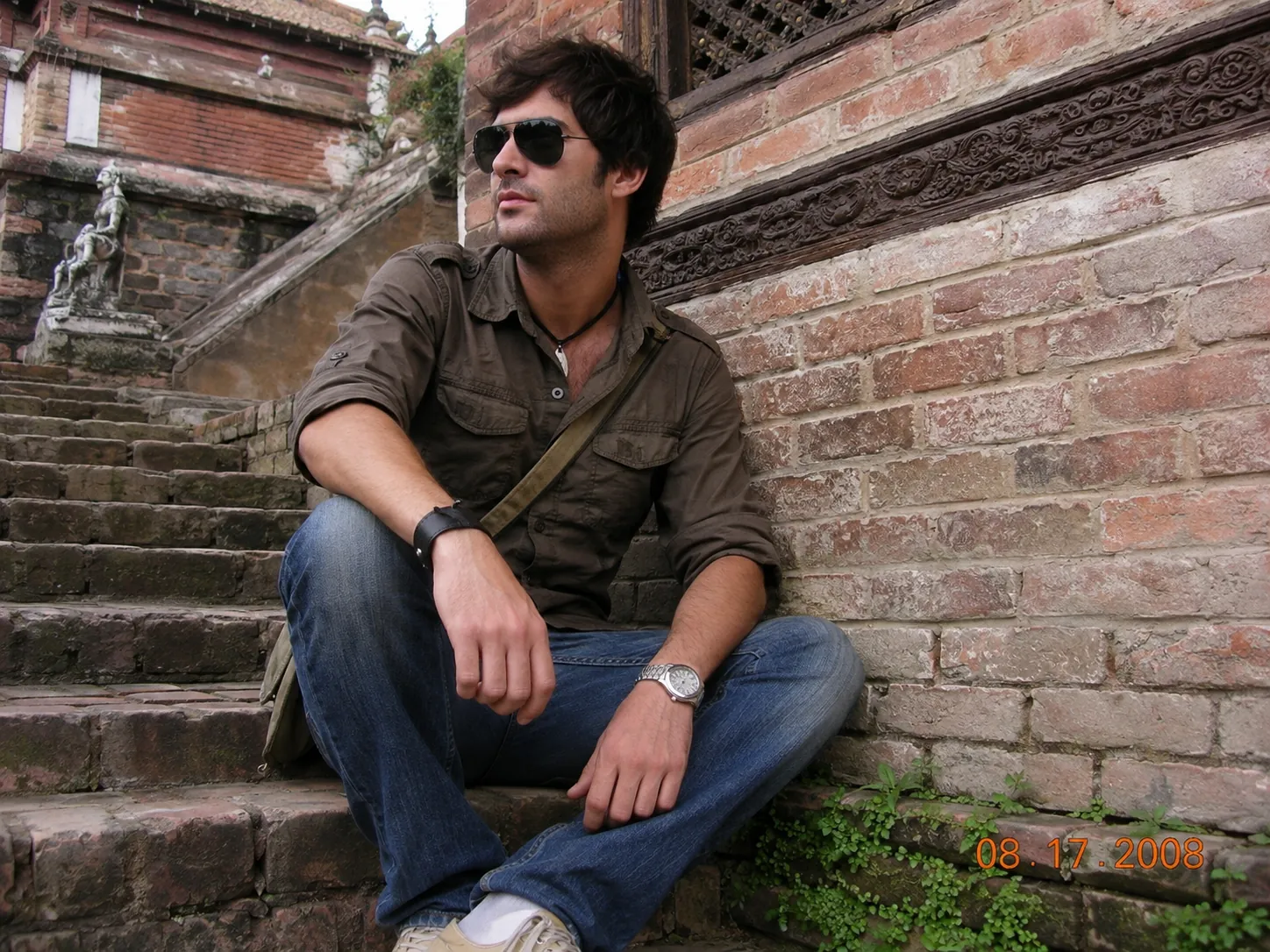 Portrait beside a brick wall with an orange date stamp